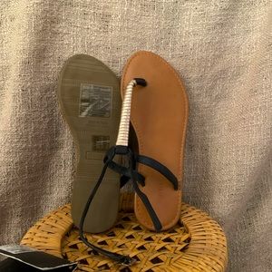 Silver and black faux leather sandals.